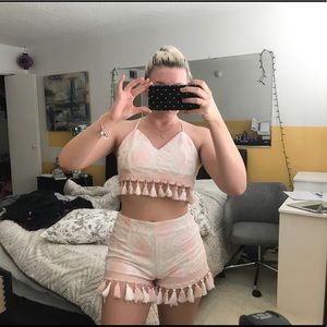 Two piece outfit with pink detailing and Pom poms